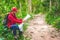 Young asian traveller man searching right direction on map in the forest. Image of lifestyle camping,travel,hiking or recreation c