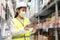 Young asian woman auditor or trainee staff wears mask working during the COVID pandemic in store warehouse shipping industrial.