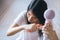 Young asian woman after bath hairbrushing her hair with comb,Female drying her long hair with dryer