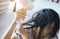 Young asian woman after bath hairbrushing her hair with comb,Female drying her long hair with dryer