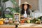 Young asian woman blogger or content creator choping tomatoes preparing vegan salad