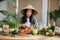 Young asian woman blogger or content creator choping tomatoes preparing vegan salad