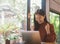 Young Asian woman celebrate success or happy pose with laptop.