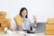 Young Asian woman chatting with a customer on a laptop and displays the product before delivery to confirm the order