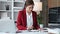 Young Asian woman checking financial statement tax documents using calculator on table at home.