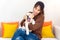Young asian woman cheerful and relax time with sweet puppy dog pet and owner having good time together at living room at home.