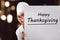 Young asian woman chef with Happy Thanksgiving message