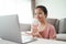 Young Asian woman deaf disabled using laptop computer for online video conference call learning and communicating in sign language