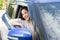 Young Asian woman driving a car and smile happily with glad positive expression during the drive to travel journey.