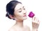 Young asian woman enjoying fragrance of red rose