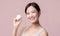 Young asian woman with facial skincare face cream, cosmetic moisturiser on healthy natural skin make up face. Portrait glowing