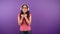 Young asian woman fashionable hipster on isolated purple background. The woman rejoices in the sudden win. 4K