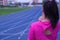 Young asian woman feel pain on her neck and shoulder while running or jogging on running track. Health care and medical concept