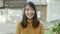 Young Asian woman feeling happy smiling to camera while traveling on street at downtown city in the evening.