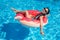 Young asian woman floating on inflatable donut