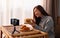 A young asian woman food blogger or vlogger showing and recording a live video of fried chicken and hamburger
