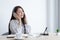 Young Asian woman happily listening to music in her private office, Relaxation by listening to music