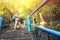 Young asian woman hiker climbing on stone stairs