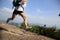 Young asian woman hiker running on mountain peak