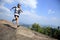 Young asian woman hiker running on mountain peak
