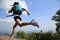 Young asian woman hiker running on mountain peak