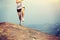 Young asian woman hiker running on mountain peak