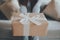 Young asian woman holding gift box and sitting on couch in living room