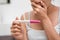 Young asian woman holding pregnancy test and shocked with result in her bathroom, wellness and healthy concept, infertility