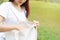 Young asian woman holding a reusable bag and walking in the park, Zero waste concept