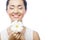 Young asian woman holding white gerber flower