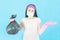 Young Asian Woman housewife in pink gloves wore face mask,garbage bag in hands  isolated on blue background,housework and