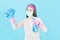 Young Asian Woman housewife in pink gloves wore face mask in hands spray for washing windows,Wipe clean isolated on blue backgroun