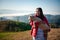 Young Asian woman is hugging intimately a little lamb at sheep farm in the morning