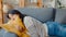 Young asian woman lay down on comfortable sofa in living room sleep after hard time work day and feel sick and bad, tired female