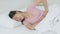 Young asian woman lying on bed pain stomach or bowel with disease constipation or indigestion in the bedroom at home.