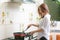 Young asian woman making omelette in a kitchen.