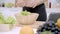 Young Asian woman making salad healthy food while using tablet for looking recipe in the kitchen, beautiful female use vegetables.