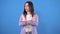 Young asian woman with a negative gesture shows no on a blue background