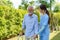 Young Asian woman nurse care giver helping senior old man with mobility walker in garden at home. Senior daycare center, Nurse