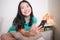 Young Asian woman online - lifestyle home portrait of happy and beautiful Chinese girl on bed using internet on mobile phone