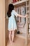 Young asian woman opening wardrobe doors full body shot