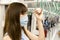 Young Asian woman passenger wearing surgical mask and listening music via mobile phone in subway train