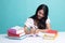 Young Asian woman read a book with books on table