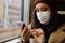 Young Asian Woman In Respirator Mask Using Smartphone In A Train. Ecological Pollution Air Infection Coronavirus Concept