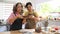 Young asian woman an retired woman enjoying pottery workshop in cozy studio