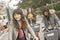 Young Asian woman riding bicycle with friends