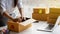 A young Asian woman selling things online starts a small business in a cardboard box at work. The seller provides a delivery box