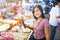 Young asian woman shopping for squid on ice in local market stall with fresh seafood