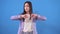 Young asian woman shows a thumbs down on a blue background