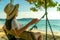 Young Asian woman sit and relax on swings at seaside on summer vacation. Summer vibes. Woman travel alone on holiday. Backpacker